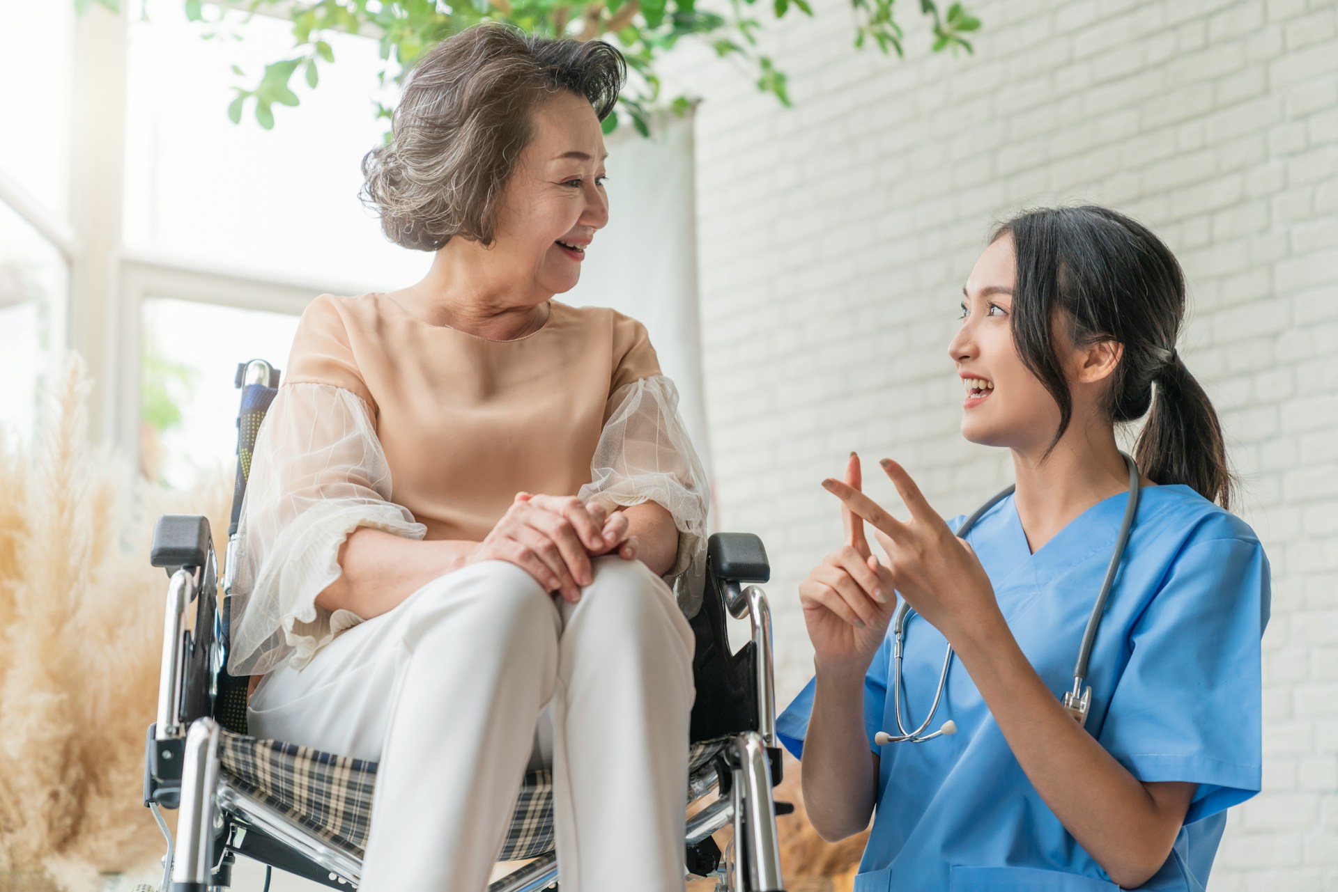 Caregiver with senior residents in a bright, welcoming senior living facility