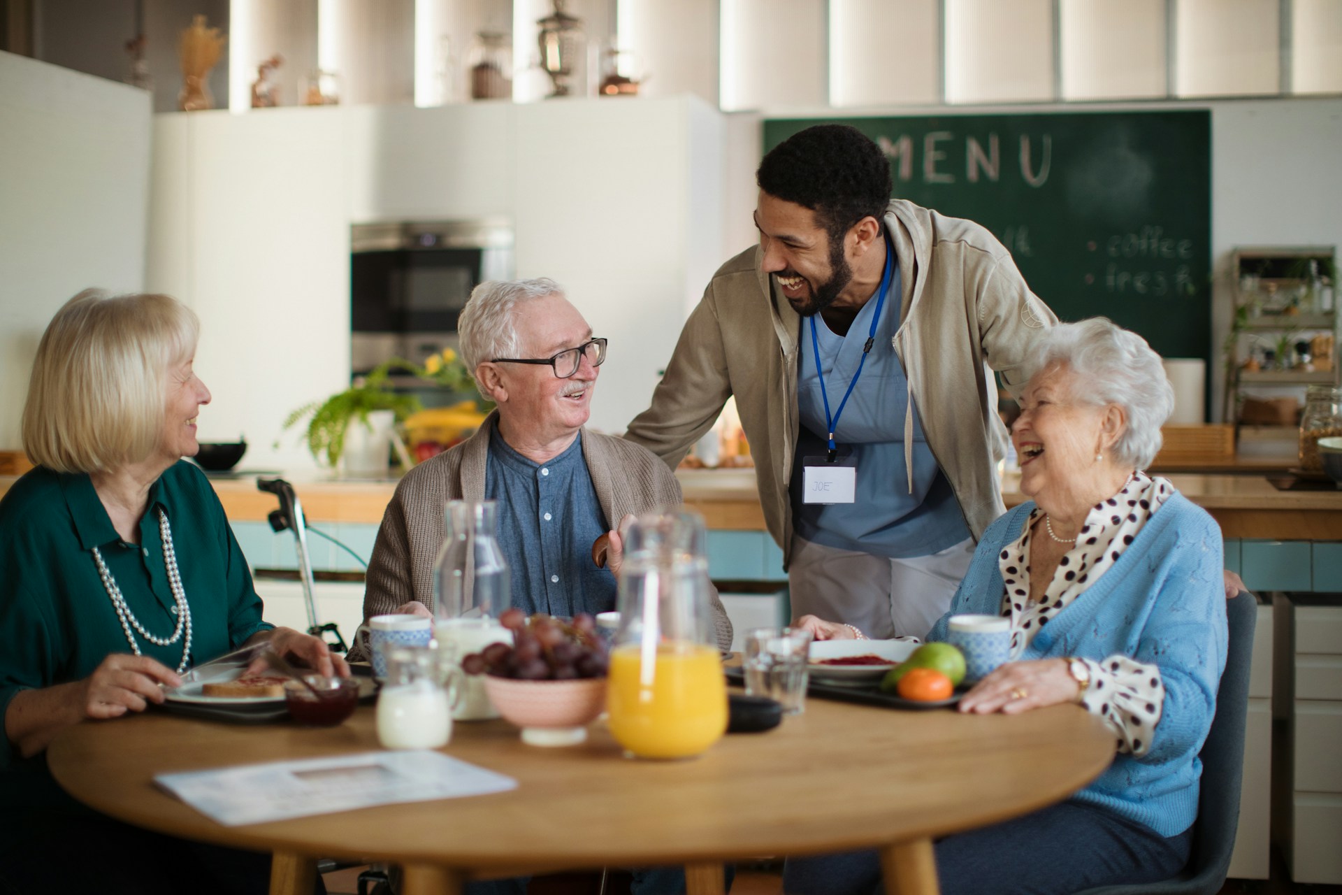 Caregiver with senior residents at a senior living facility
