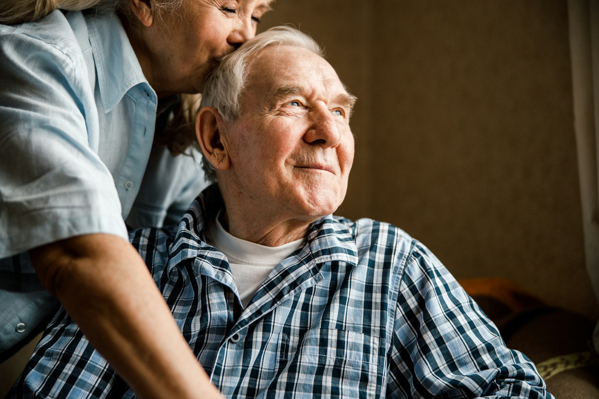 Nurse attentively checking on an elderly patient